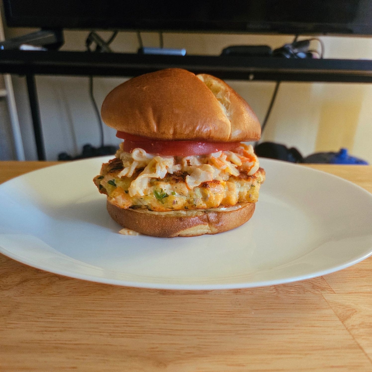 Salmon Burger with Sriracha Imitation Crab Salad, Tomato, and Cilantro Lime Aioli